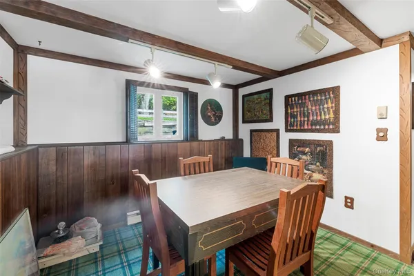 a view of a dining room with furniture and window