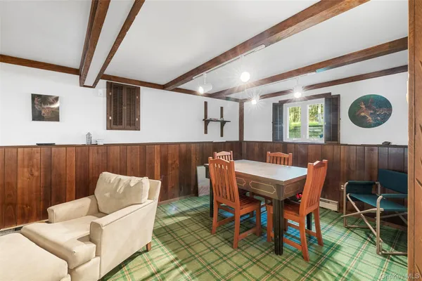 a view of a dining room with furniture and a rug