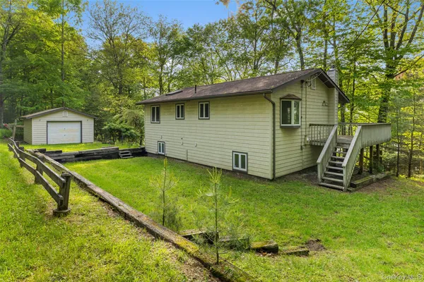 a view of a house with a yard patio and a swimming pool