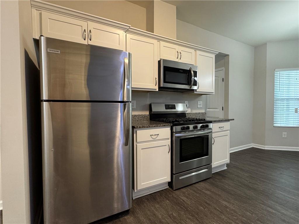 98 Baywood Way Hiram, GA 30141 - Photo 16 of 55 a white refrigerator freezer sitting in a kitchen