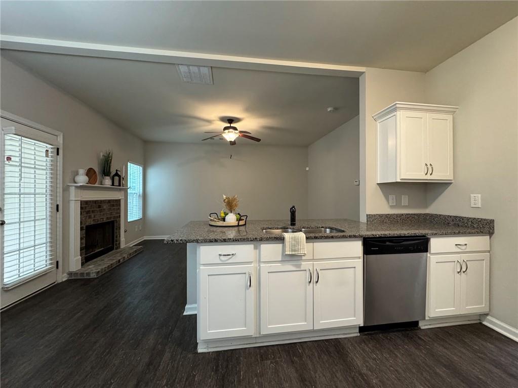 98 Baywood Way Hiram, GA 30141 - Photo 18 of 55 a kitchen with stainless steel appliances white cabinets and wooden floor