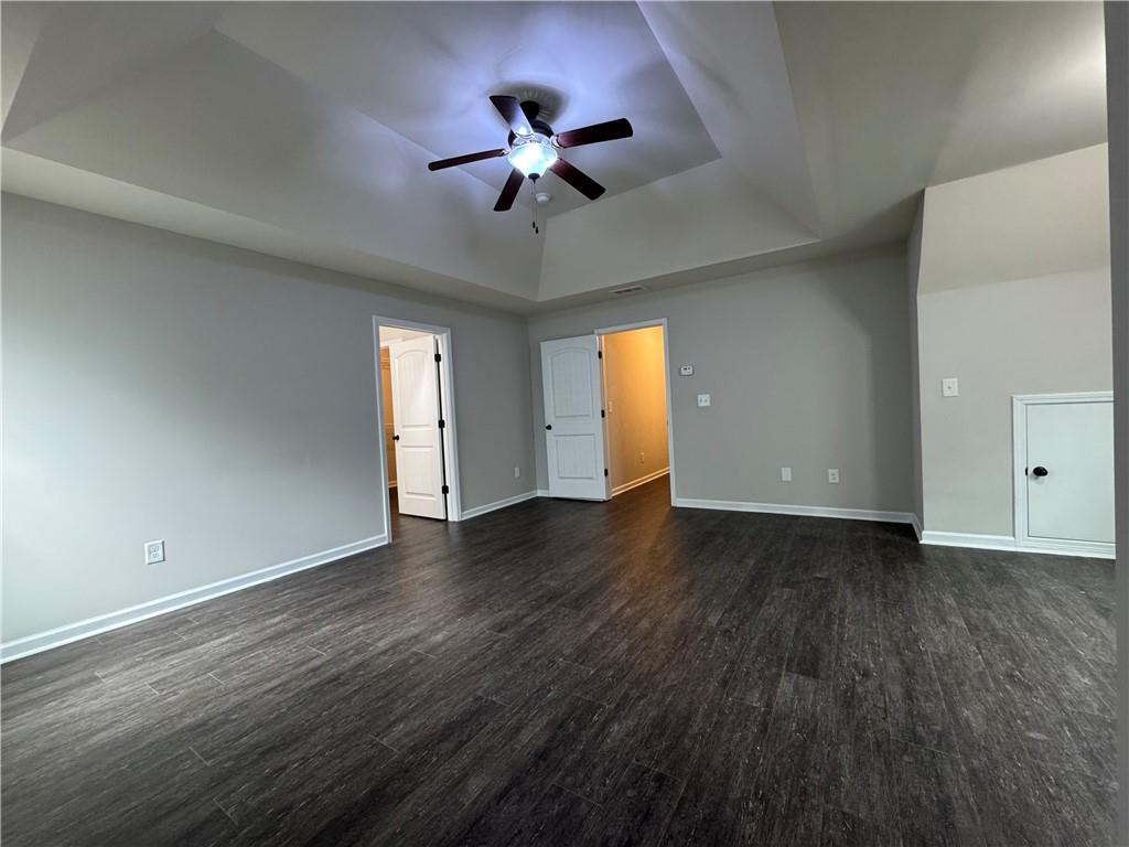 98 Baywood Way Hiram, GA 30141 - Photo 25 of 55 a view of an empty room with wooden floor and a ceiling fan