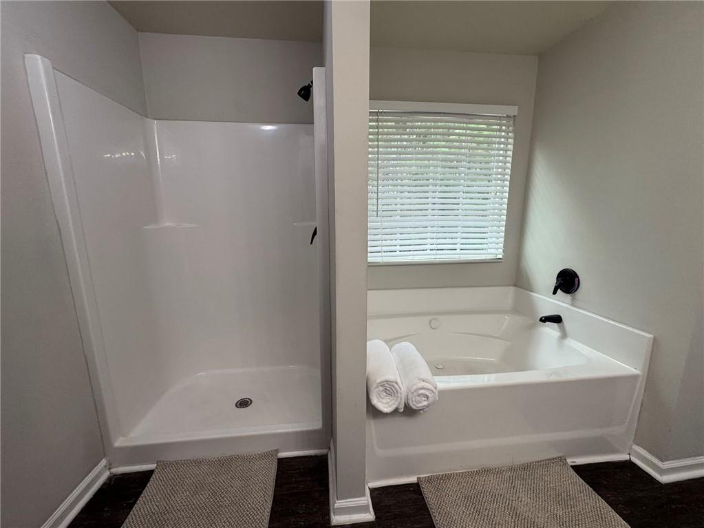 98 Baywood Way Hiram, GA 30141 - Photo 31 of 55 a bathroom with a tub shower and a sink