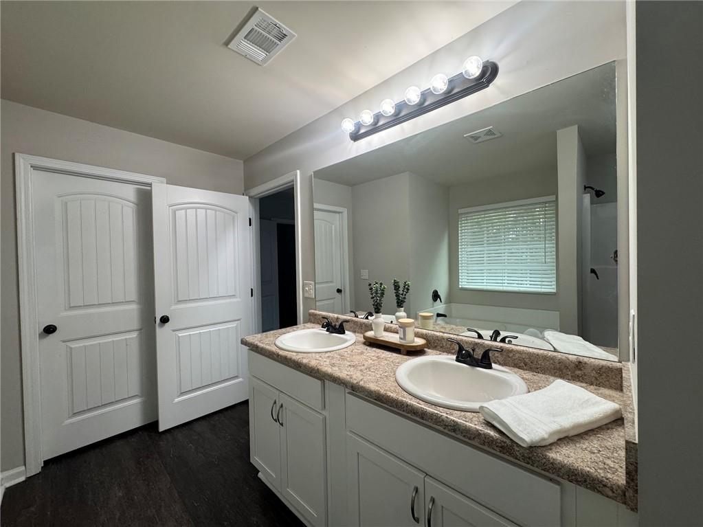 98 Baywood Way Hiram, GA 30141 - Photo 32 of 55 a bathroom with a granite countertop sink and a mirror