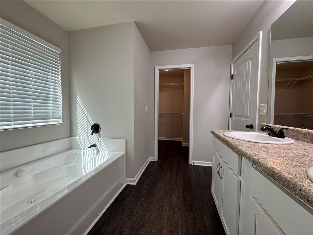98 Baywood Way Hiram, GA 30141 - Photo 35 of 55 a bathroom with a granite countertop sink a bathtub and a mirror