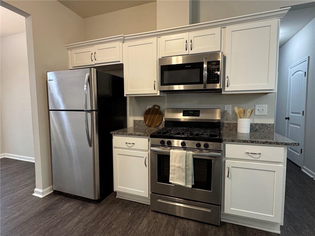 98 Baywood Way Hiram, GA 30141 - Photo 5 of 55 a kitchen with stainless steel appliances a refrigerator microwave and sink