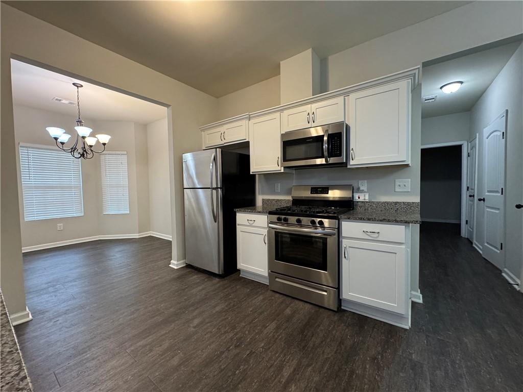 98 Baywood Way Hiram, GA 30141 - Photo 9 of 55 a kitchen with stainless steel appliances a refrigerator stove a sink and dishwasher
