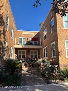 a front view of a building with sitting area