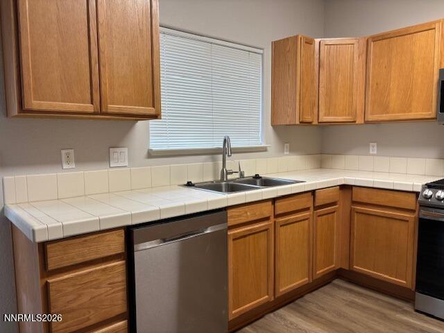 205 Dawson Jacob Ln. Reno, NV 89503 - Photo 12 of 33 a kitchen with stainless steel appliances granite countertop wooden cabinets a sink and dishwasher