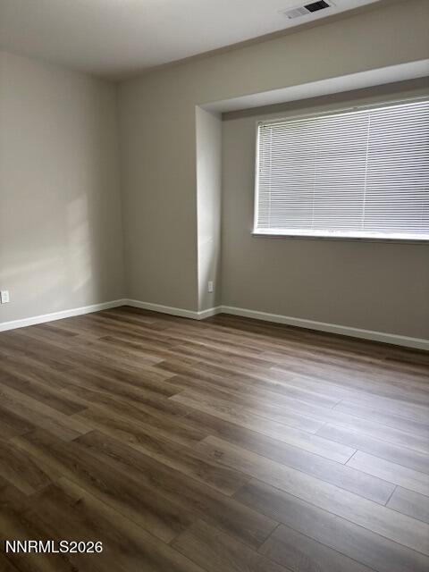 205 Dawson Jacob Ln. Reno, NV 89503 - Photo 20 of 33 a view of an empty room with wooden floor and a window
