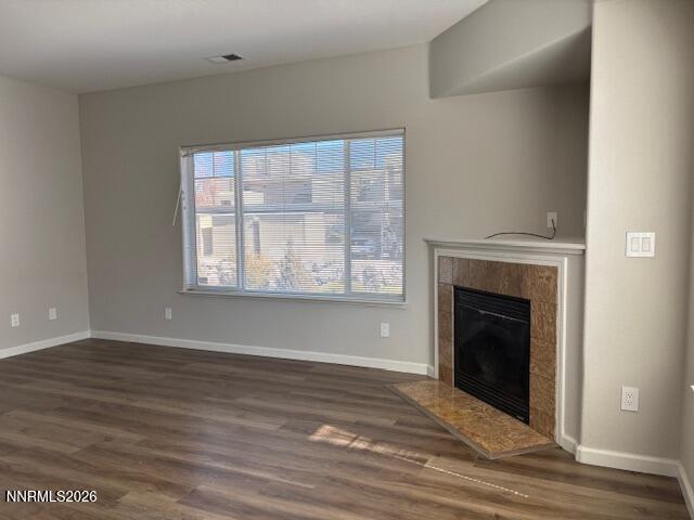 205 Dawson Jacob Ln. Reno, NV 89503 - Photo 8 of 33 an empty room with wooden floor fireplace and windows