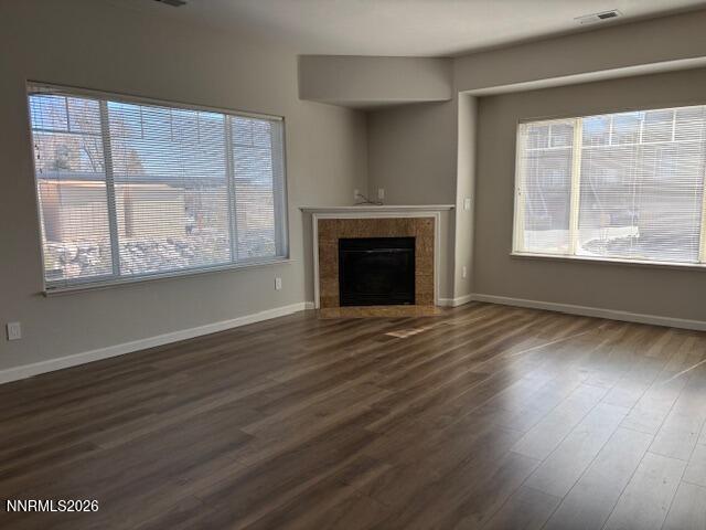 205 Dawson Jacob Ln. Reno, NV 89503 - Photo 9 of 33 an empty room with wooden floor fireplace and windows