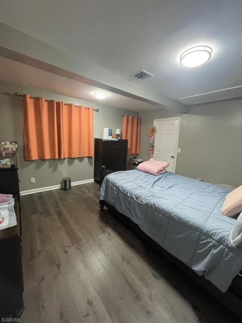 162 Lyon Street Paterson, NJ 07524 - Photo 12 of 25 a spacious bedroom with a bed and window