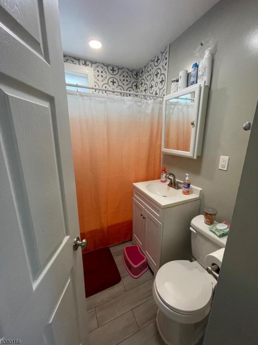 162 Lyon Street Paterson, NJ 07524 - Photo 18 of 25 a bathroom with a sink toilet and shower