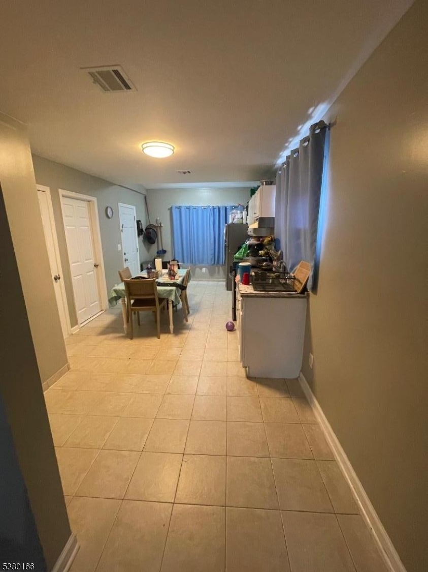 162 Lyon Street Paterson, NJ 07524 - Photo 3 of 25 a kitchen with stainless steel appliances granite countertop a sink and a refrigerator