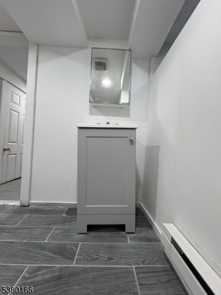 162 Lyon Street Paterson, NJ 07524 - Photo 8 of 25 a view of an empty room with wooden floor