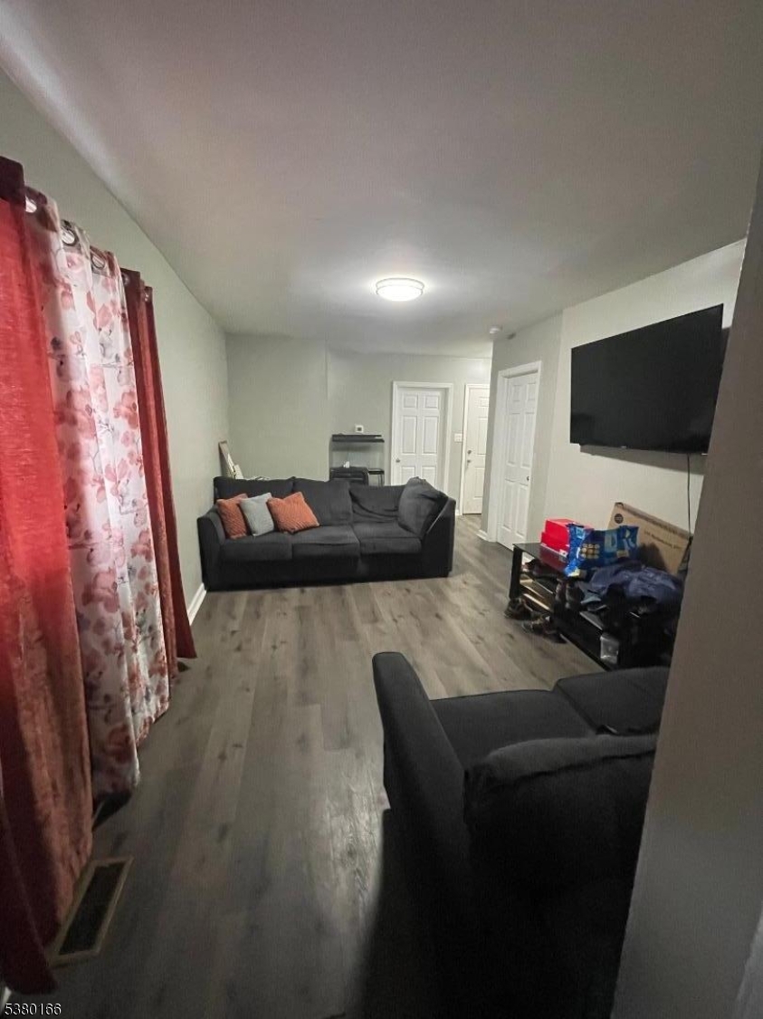 162 Lyon Street Paterson, NJ 07524 - Photo 10 of 25 a living room with furniture and a flat screen tv