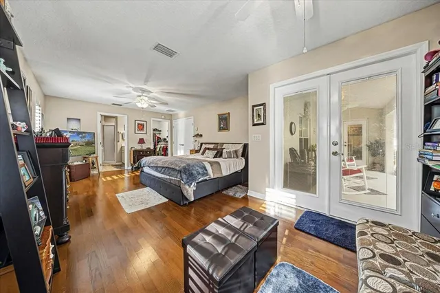 a bedroom with furniture and wooden floor
