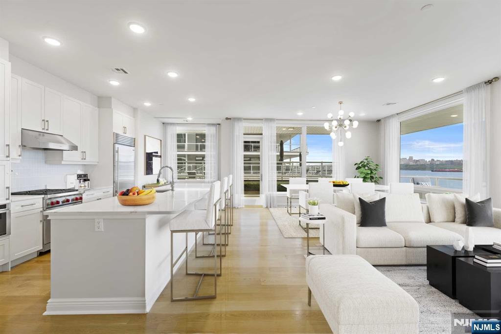 a living room with fireplace furniture and a wooden floor