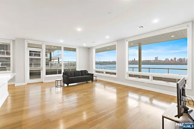 a living room with furniture window and wooden floor