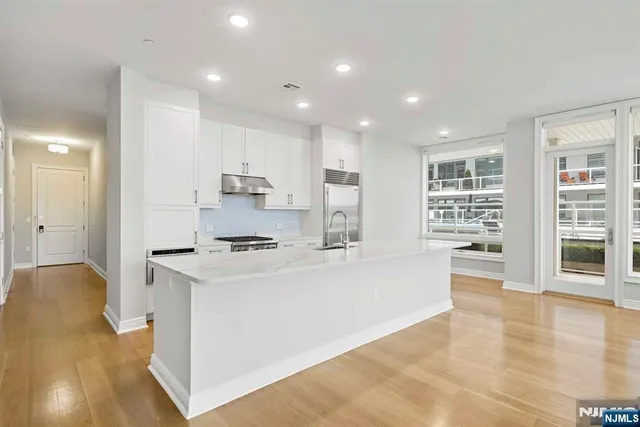 a kitchen with stainless steel appliances granite countertop a stove and a refrigerator