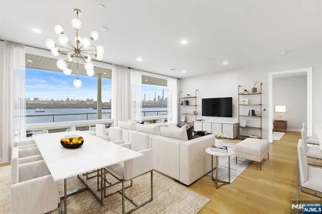 a living room with furniture a chandelier and a flat screen tv