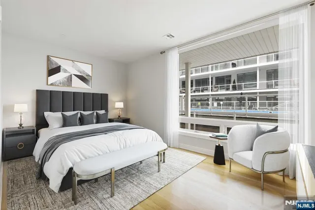 a bedroom with a bed and a chair