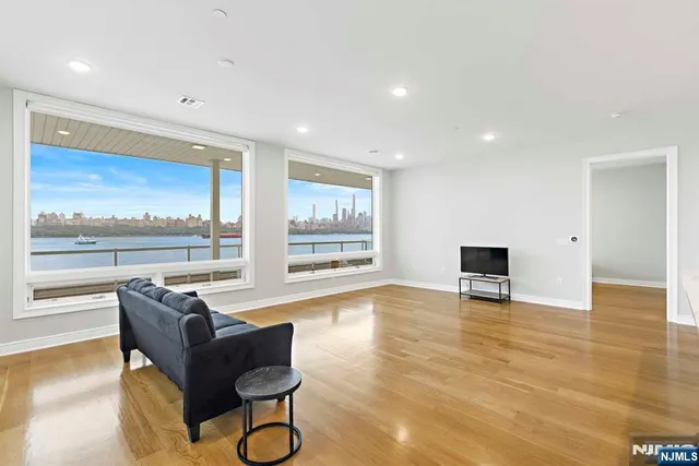 a living room with furniture and a floor to ceiling window