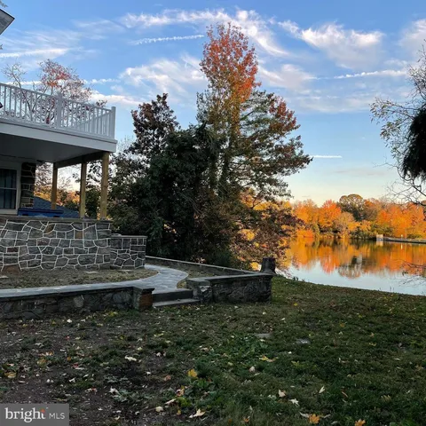 a view of a kitchen with kitchen island wooden floor center island and stainless steel appliances