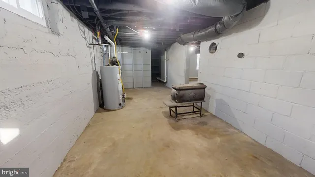 a view of an empty room with wooden floor and stairs