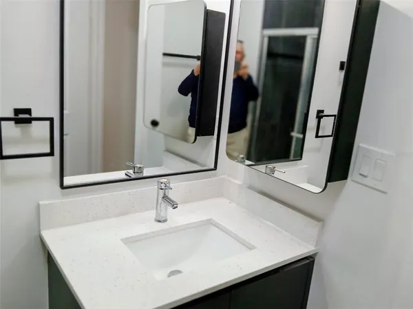a bathroom with a sink and a mirror
