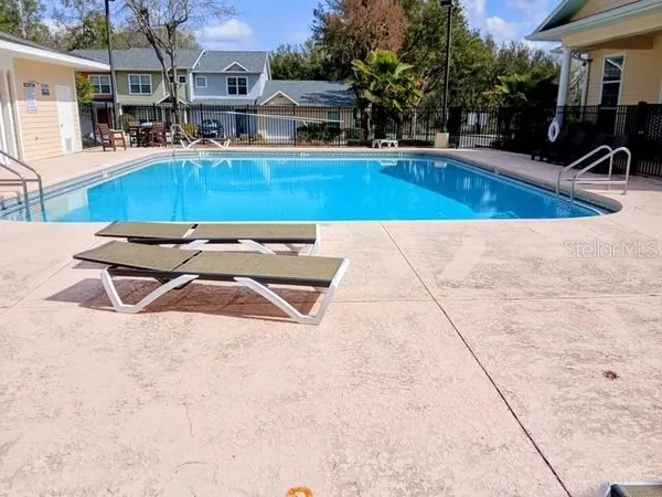 a view of swimming pool with outdoor seating