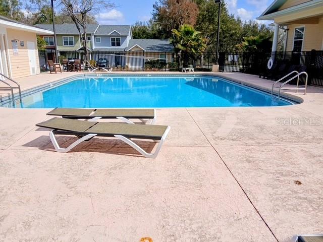 1583 Northwest 29 Road, Unit 2 Gainesville, FL 32605 - Photo 15 of 20 a view of swimming pool with outdoor seating