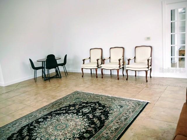 1583 Northwest 29 Road, Unit 2 Gainesville, FL 32605 - Photo 16 of 20 a living room with chairs and a rug