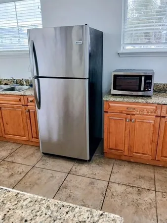 a white refrigerator freezer sitting in a kitchen