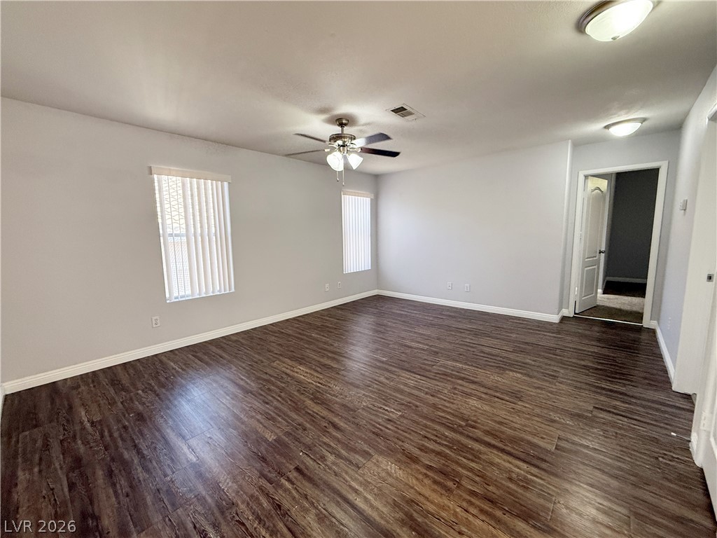 2185 Polynesia Circle Henderson, NV 89074 - Photo 26 of 37 Rich hardwood-style flooring extends across this spacious, naturally illuminated living area.