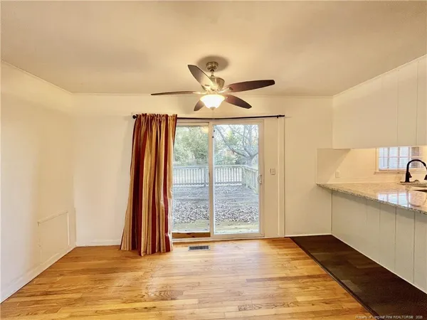 a view of a livingroom with a ceiling fan and window