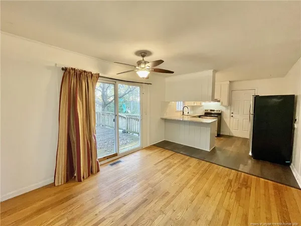 a view of a kitchen with a sink and a refrigerator