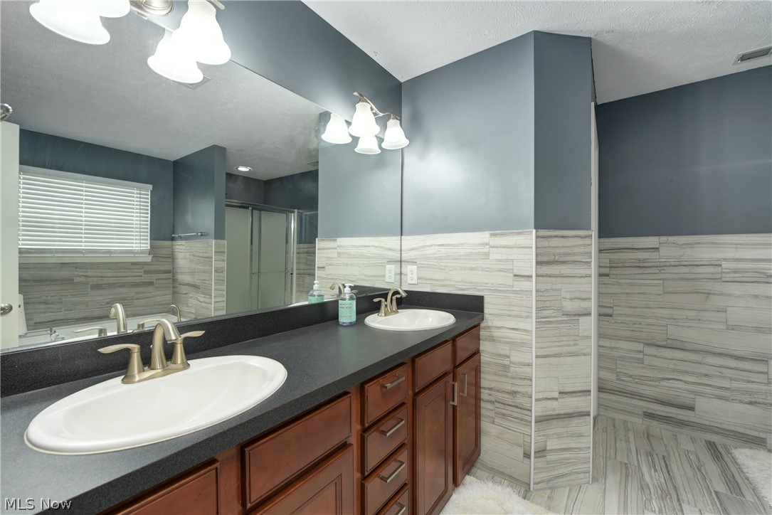 3600 Case Road Avon, OH 44011 - Photo 19 of 35 Renovated masterbath with beautiful tile, double vanities, upscale cabinetry