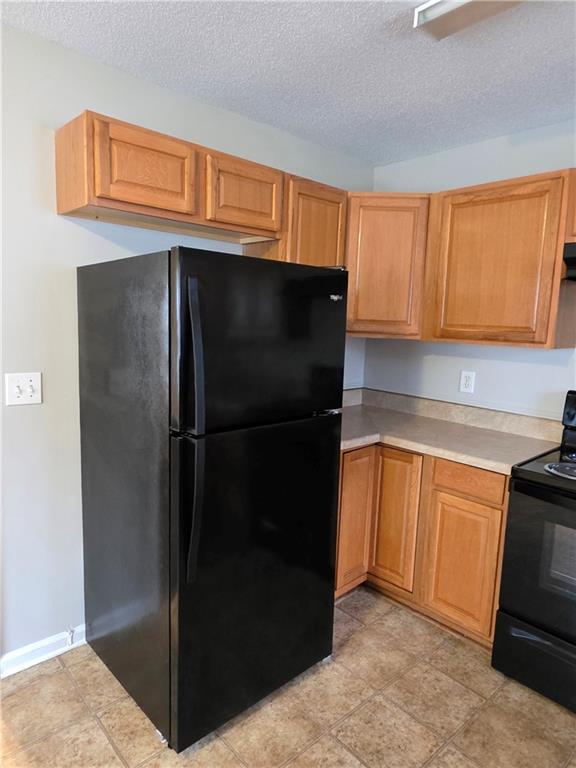 2325 Shady Grove Road, Unit A Carrollton, GA 30116 - Photo 11 of 42 a kitchen with stainless steel appliances granite countertop a refrigerator and a sink