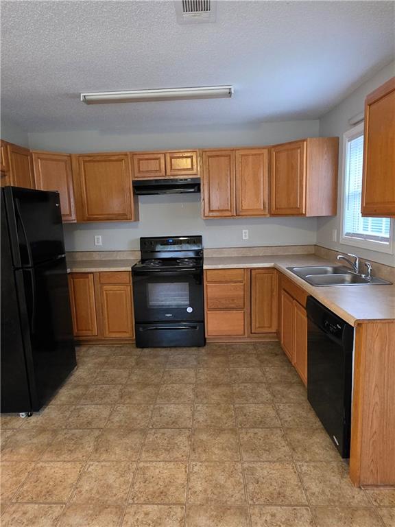 2325 Shady Grove Road, Unit A Carrollton, GA 30116 - Photo 12 of 42 a kitchen with stainless steel appliances granite countertop a stove a sink and a refrigerator