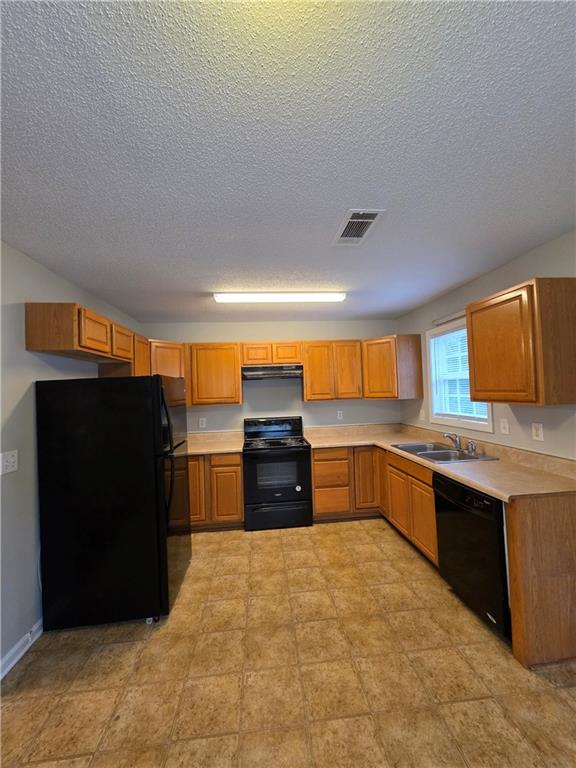 2325 Shady Grove Road, Unit A Carrollton, GA 30116 - Photo 15 of 42 a kitchen with stainless steel appliances granite countertop a refrigerator and a sink