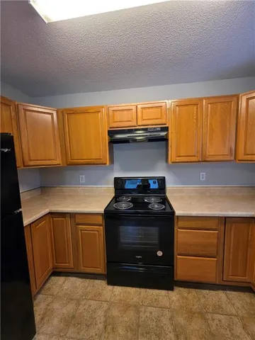 a kitchen with a stove and a cabinet