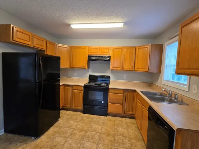 a kitchen with a refrigerator and a sink