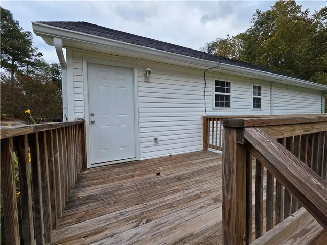 a view of deck with wooden floor and fence and a floor to ceiling window