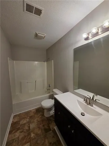 a bathroom with a sink toilet a mirror and vanity