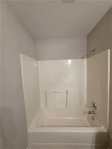 a bathroom with a bathtub and shower