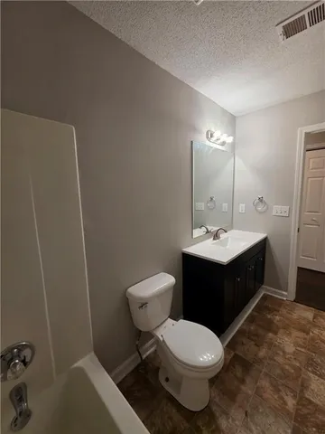 a bathroom with a sink toilet and mirror