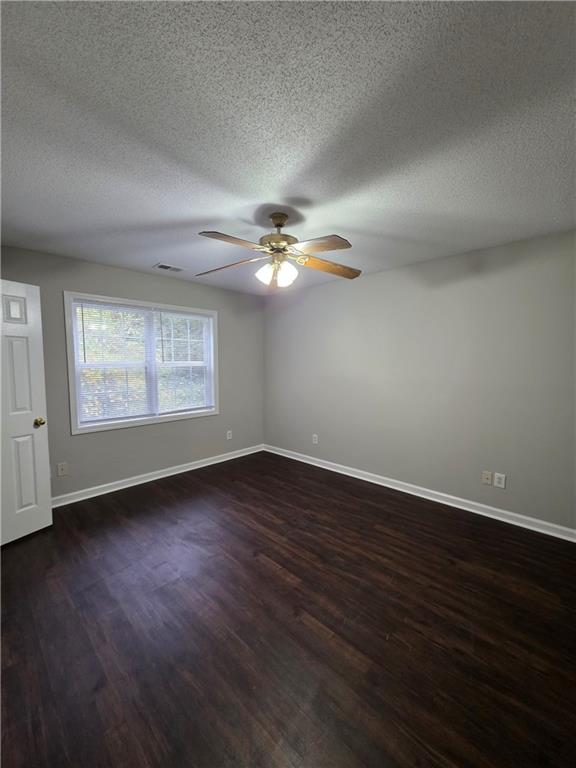 2325 Shady Grove Road, Unit A Carrollton, GA 30116 - Photo 32 of 42 a view of a livingroom with a fan a window and wooden floor