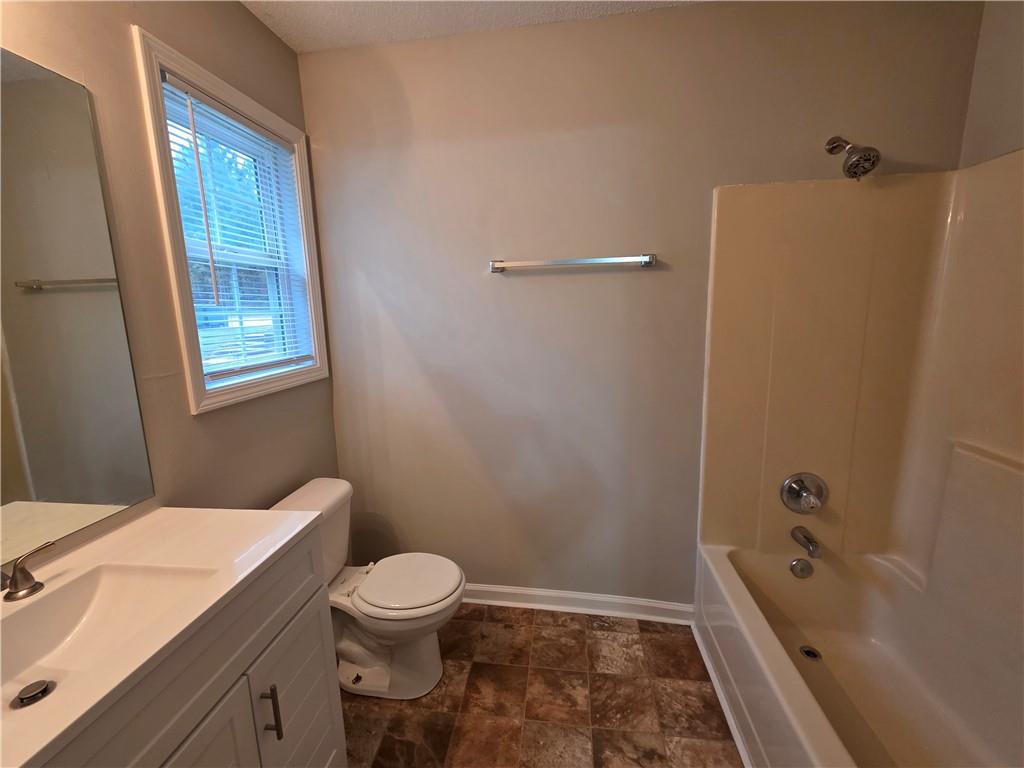 2325 Shady Grove Road, Unit A Carrollton, GA 30116 - Photo 41 of 42 a bathroom with a sink a toilet and shower